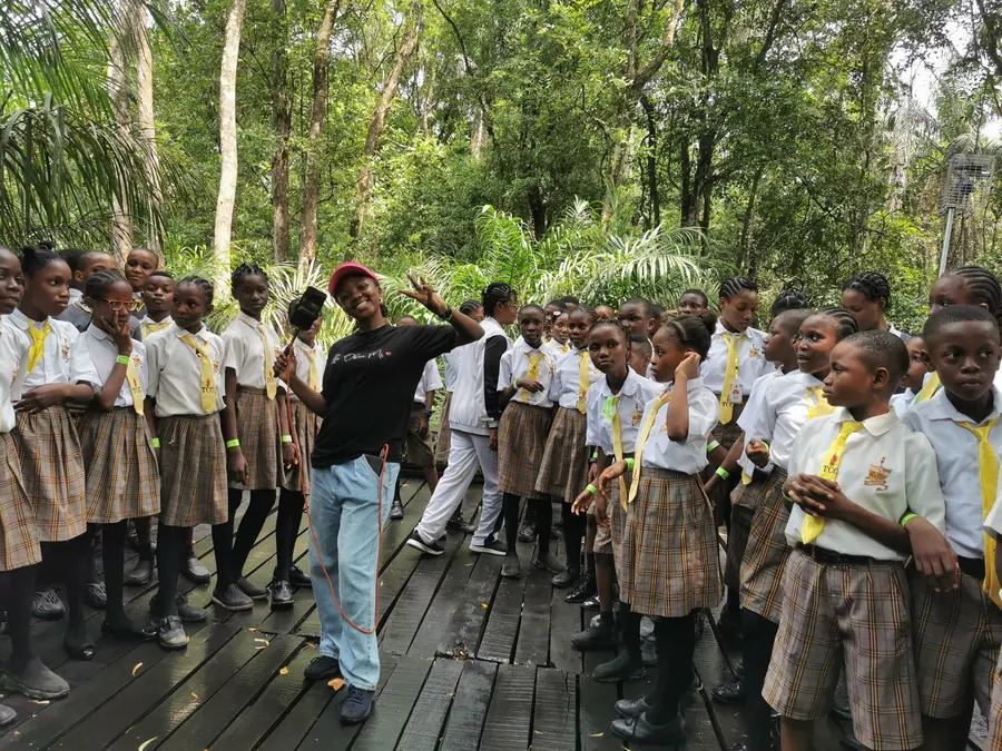 Students on a school trip lined up along a forest boardwalk
