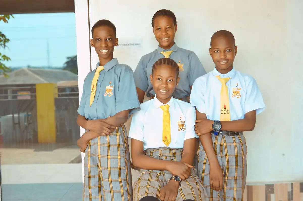Four students of The Chosen College in uniform with yellow ties