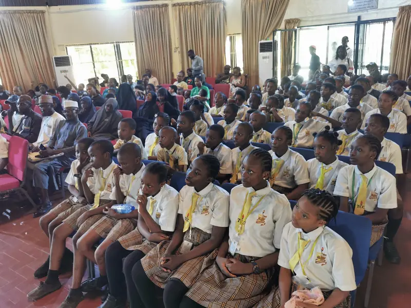 Students and parents seated together in a hall