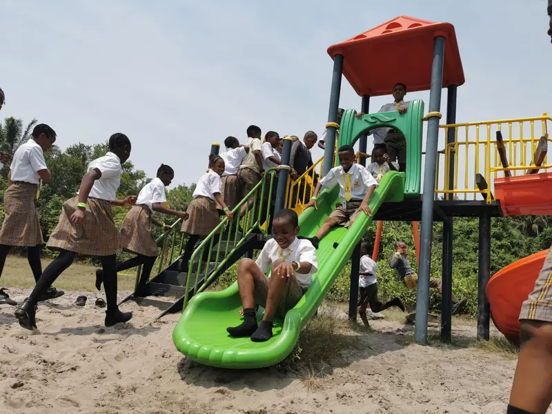 Pupils sliding and climbing on a playground